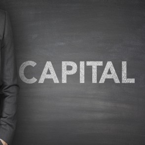 Capital on blackboard